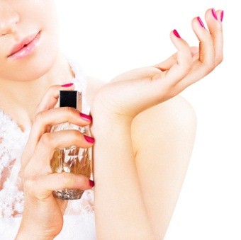 woman spraying perfume